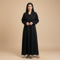 black jacquard abaya with a brooch.
