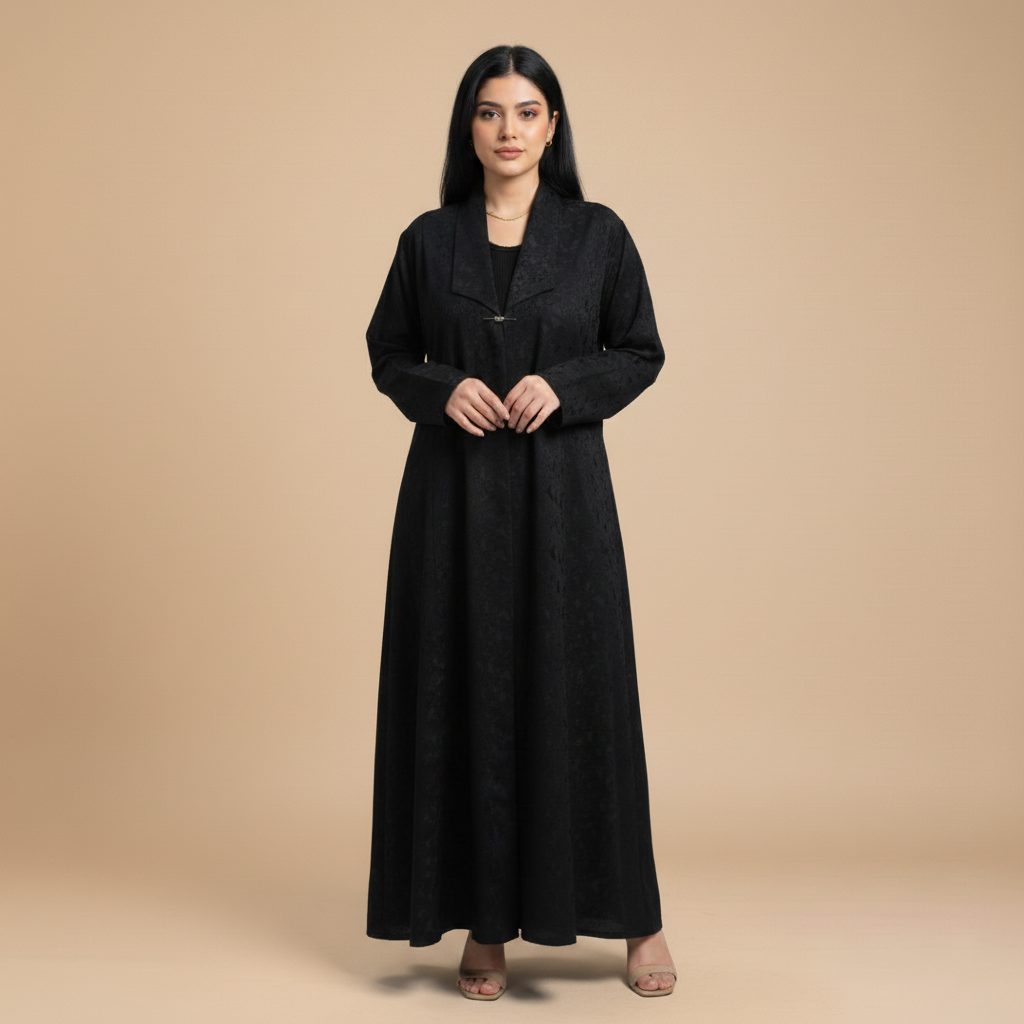 black jacquard abaya with a brooch.