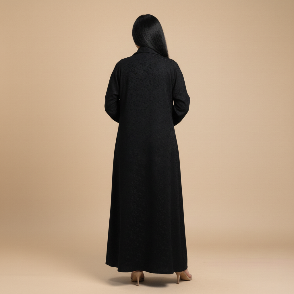 black jacquard abaya with a brooch.