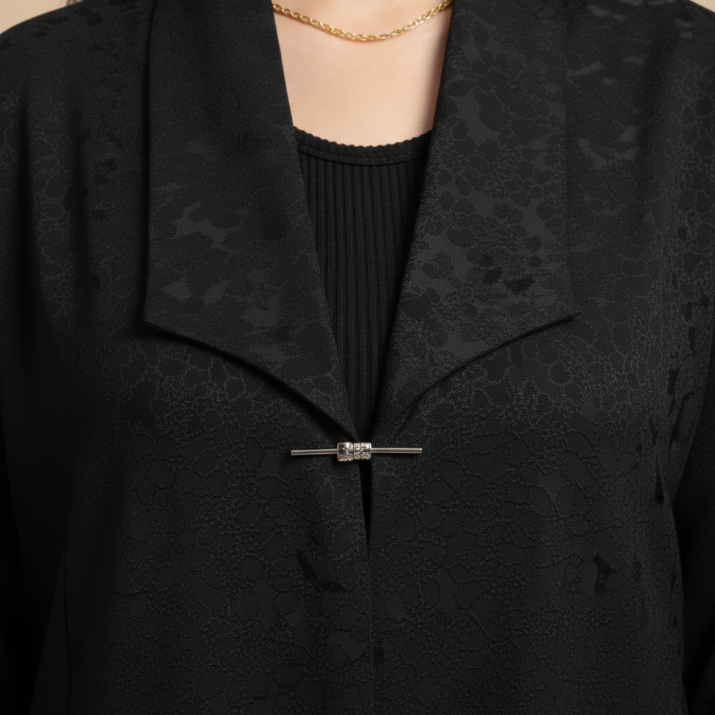 black jacquard abaya with a brooch.