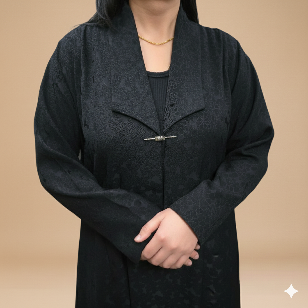 black jacquard abaya with a brooch.
