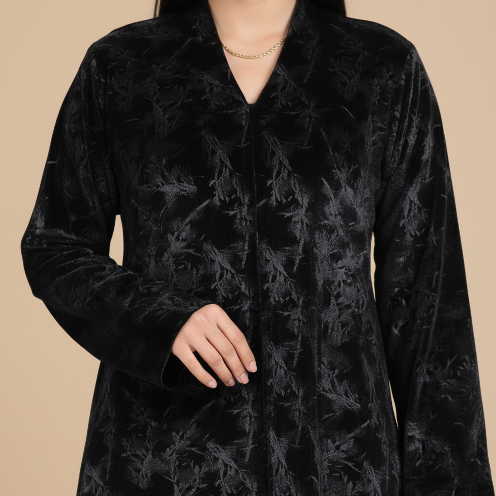 black cold-velvet abaya with botanical pattern.