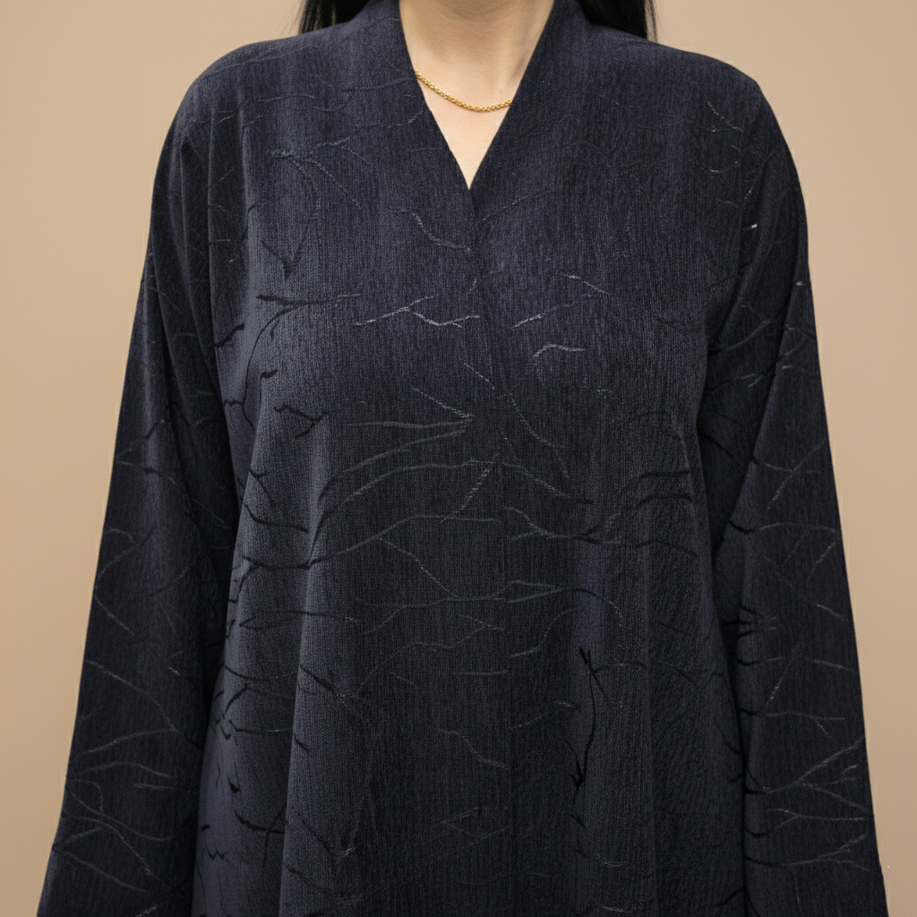 A velvet abaya with a subtle pattern.