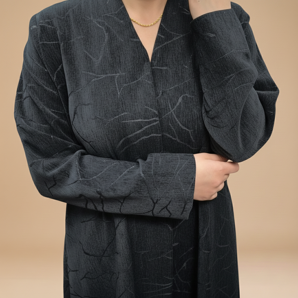 A velvet abaya with a subtle pattern.
